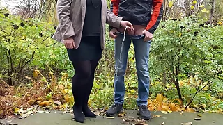 Hot milf in pantyhose and skirt holding guy's cock outdoors greatest extent pissing